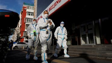 Pandemic prevention workers in protective suits walk near an apartment compound that was placed under lockdown as outbreaks of the coronavirus disease (COVID-19) continue in Beijing, China, November 12, 2022. (Reuters)