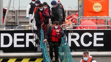 Migrants who arrived onboard a Border Force rescue boat are escorted by Border Force staff, after having crossed the channel, at Dover harbour in Dover, Britain. (File photo: Reuters)