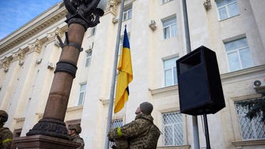Ukrainian serviceman takes part in a national flag raising ceremony in Kherson, recently recaptured by Ukrainian Armed Forces, Ukraine November 14, 2022. Ukrainian Presidential Press Service/Handout via REUTERS ATTENTION EDITORS - THIS IMAGE HAS BEEN SUPPLIED BY A THIRD PARTY.