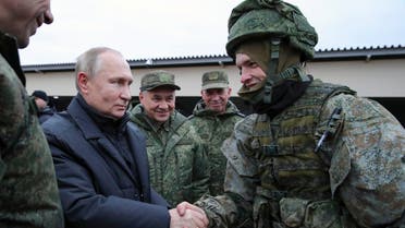 FILE - Russian President Vladimir Putin shakes hands with a soldier as he visits a military training centre of the Western Military District for mobilised reservists as Russian Defense Minister Sergei Shoigu, center, smiles in Ryazan Region, Russia, Thursday, Oct. 20, 2022. The mobilized reservists that Russian President Vladimir Putin visited last week at a firing range southeast of Moscow looked picture-perfect. (Mikhail Klimentyev, Sputnik, Kremlin Pool Photo via AP, File)