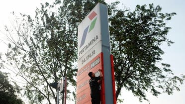 A worker of a petrol station of the state-owned company Pertamina changes the fuel prices displayed after the announcement of a fuel price hike, in Bekasi, on the outskirts of Jakarta, Indonesia, September 3, 2022. (Reuters)
