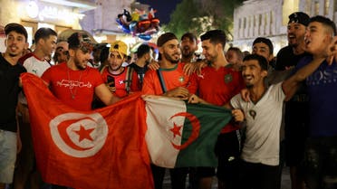 Arab fans with Tunisia and Algeria flags cheer at a popular tourist area in Souq Waqif, ahead of the FIFA World Cup 2022 soccer tournament in Doha, Qatar November 13, 2022. (Reuters)