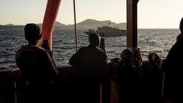 Migrants stand on board the Ocean Viking prior disembarking in Toulon, France on November 11, 2022, after being rescued by European maritime-humanitarian organization “SOS Mediterranee.” (AFP)