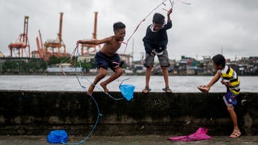 Children play with their makeshift kites following heavy rains brought by the Tropical Storm Nalgae (Paeng) in Manila, Philippines, October 29, 2022. (Reuters)