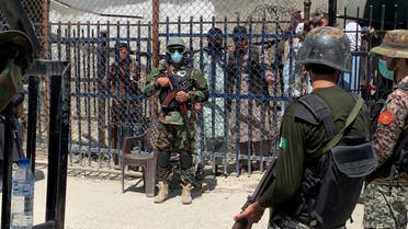 Pakistani soldiers stand guard in front of a member of the Taliban force, in the background, during an organised media tour to the Pakistan-Afghanistan crossing border, in Torkham, Pakistan. (File photo: Reutes)