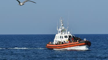 An Italian Guardia Costiera boat with migrants from Tunisia and Lybia arrives in the port of the Italian Pelagie Island of Lampedusa on August 1, 2020. (AFP)