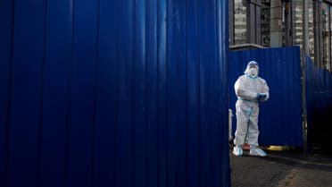 A pandemic prevention worker in a protective suit stands outside an apartment compound that was placed under lockdown as outbreaks of the coronavirus disease (COVID-19) continue in Beijing, China, November 12, 2022. REUTERS/Thomas Peter