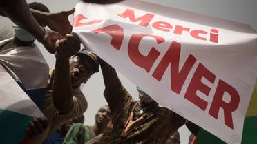 Protesters holds a banner reading “Thank you Wagner,” the name of the Russian private security firm present in Mali, during a demonstration organised by the pan-Africanst platform Yerewolo to celebrate France’s announcement to withdraw French troops from Mali, in Bamako, on February 19, 2022. (AFP)