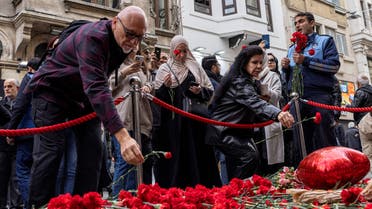FILE PHOTO: People lay flowers to pay tribute to the victims of a Sunday's blast that took place on Istiklal Avenue, a popular spot for shoppers and tourists, in Istanbul, Turkey, November 14, 2022. REUTERS/Umit Bektas/File Photo