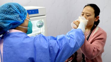 A resident takes an inhaled COVID-19 vaccine produced by Chinese pharmaceutical firm CanSino Biologics, at a community health service centre in Lianyungang, Jiangsu province, China November 3, 2022. (Reuters)