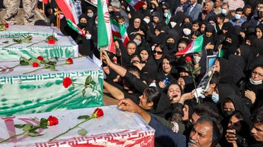 Iranians mourn in front of the coffins of people killed in a shooting attack, during their funeral in the city of Izeh in Iran's Khuzestan province, on November 18, 2022. In some of the worst violence since the protests erupted, assailants on motorbikes shot dead seven people, including a woman and two children aged nine and 13, at a central market of Izeh on the evening of November 16, 2022, state media said. (Photo by ALIREZA MOHAMMADI / ISNA / AFP)
