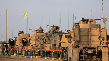 American soldiers stand near military trucks, at al-Omar oil field in Deir Al Zor in 2019. (Reuters)