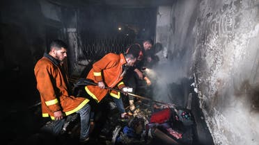 Palestinian firefighters extinguish a fire which broke out in one of the apartments in the Jabalia refugee camp in the northern Gaza strip, on November 17, 2022. (AFP)