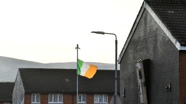 An Ireland flag flutters beside an old prison door that is affixed to the side of a house as a memorial to Republican prisoners, in the nationalist Ardoyne area of North Belfast, Northern Ireland, April 29, 2022. Picture taken April 29, 2022. REUTERS/Clodagh Kilcoyne
