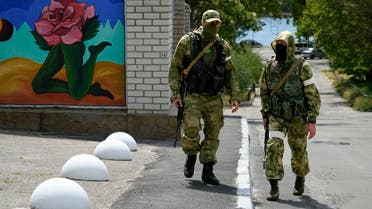 FILE - Two Russian soldiers patrol an administrative area at the Khersonvodokanal (water channel) in Kherson, Kherson region, south Ukraine, on May 20, 2022. In the southern city of Kherson, one of the first seized by Russia and a key target of an unfolding Ukrainian counteroffensive, the Ukrainian mayor tried to stand his ground. As Russians seized parts of eastern and southern Ukraine in the 8-month-old war, mayors, civilian administrators and others, including nuclear power plant workers, say they have been abducted, threatened or beaten to force their cooperation. (AP Photo, File)