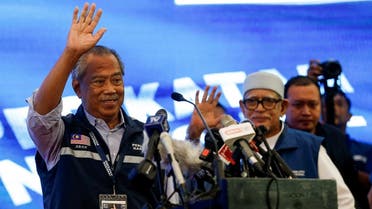 Muhyiddin Yassin waves as he attends a news conference after Malaysia’s 15th general election in Shah Alam, Malaysia, on November 20, 2022. (Reuters)