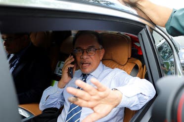 Malaysian opposition leader Anwar Ibrahim gestures as he leaves his office in Petaling Jaya, Malaysia, on November 22, 2022. (Reuters)
