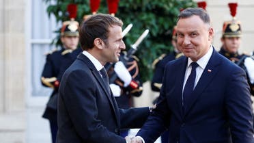 French President Emmanuel Macron welcomes Polish President Andrzej Duda as he arrives for a lunch meeting at the Elysee Palace in Paris, France, October 27, 2021. REUTERS/Christian Hartmann