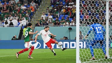 Poland's midfielder #10 Grzegorz Krychowiak (C) attempts to score past Mexico's defender #19 Jorge Sanchez (L) during the Qatar 2022 World Cup Group C football match between Mexico and Poland at Stadium 974 in Doha on November 22, 2022. (AFP)
