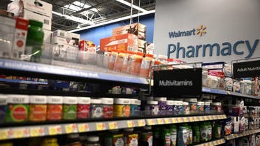 A sign for Walmart Pharmacy is seen inside a Walmart. (AFP)