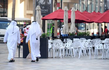 Emirati men walk along the empty beachside boulevard of Jumeirah Beach Residence which is usually crowded, in the Gulf emirate of Dubai on March 12, 2020. (File photo: AFP)