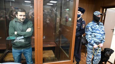 Russian opposition figure and Moscow city councilor Ilya Yashin stands inside a defendants’ cage in Moscow on November 23, 2022 at the opening of his trial before the Tverskoy district court that could land him in prison for up to a decade, on charge of “discrediting” the Russian army. (AFP)