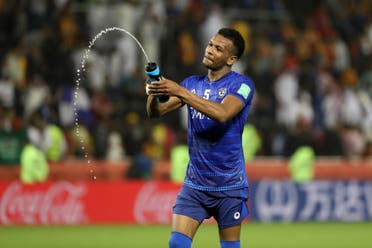 Al Hilal's defender Ali al-Bulaihi sprinkles water as he celebrates his team's victory after the 2019 FIFA Club World Cup quarter-final football match between Hilal and Esperance de Tunis at Jassim Bin Hamad Stadium in Doha on December 14, 2019. (AFP)