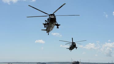 Sea-King helicopters fly past during a beach landing demonstration during D-Day commemorations in Portsmouth in southern England on June 5, 2014. (AFP)