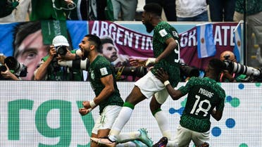 audi Arabia's forward #11 Saleh Al-Shehri (L) celebrates with teammates after scoring his team's first goal during the Qatar 2022 World Cup Group C football match between Argentina and Saudi Arabia at the Lusail Stadium in Lusail, north of Doha on November 22, 2022. (AFP)