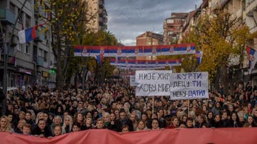 Serb women hold placards reading We want Peace (L) and Kurti, (Kosovo Prime Minister) we will not give you our children (R) during a protest in the Serb predominant part of Mitrovica on November 23, 2022. (AFP)