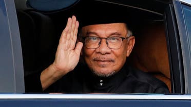 Malaysian new Prime Minister Anwar Ibrahim waves at the photographer as he arrives at the National Palace in Kuala Lumpur, Malaysia, on November 24, 2022. (Reuters)