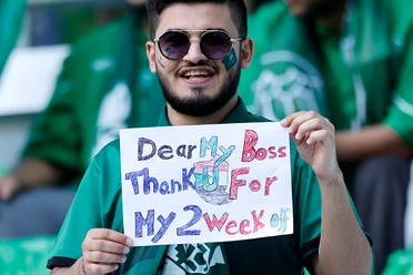 A Saudi Arabia supporter displays a placard while waiting for the start of the Qatar 2022 World Cup Group C football match between Poland and Saudi Arabia at the Education City Stadium in Al-Rayyan, west of Doha on November 26, 2022. (AFP)
