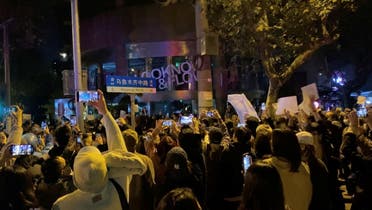 People take part in a protest against COVID-19 curbs in Shanghai, China, November 27, 2022, in this screen grab obtained from a social media video. (Reuters)