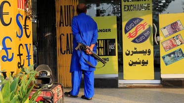 A security guard patrols outside a currency exchange in Islamabad, Pakistan. (Reuters)