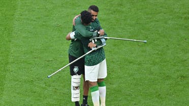  Saudi Arabia's midfielder #07 Salman Al-Faraj and Saudi Arabia's midfielder #10 Salem Al-Dawsari hug as they celebrate the team's victory during the Qatar 2022 World Cup Group C football match between Argentina and Saudi Arabia at the Lusail Stadium in Lusail, north of Doha on November 22, 2022. (Photo by Glyn KIRK / AFP)