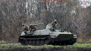 This handout photo taken from video released by Russian Defense Ministry Press Service on Saturday, Nov. 12, 2022, shows the combat work of servicemen of the Russian Radiation, Chemical and Biological Protection Troops (RCBZ) during an action at an unspecified location in Ukraine. (Russian Defense Ministry Press Service via AP)