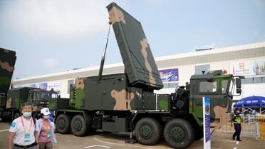 People walk past HQ-9BE air and missile defense weapon system displayed at the China International Aviation and Aerospace Exhibition, in Zhuhai, September 29, 2021. (Reuters)