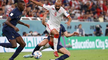 Tunisia forward Issam Jebali (9) battles for the ball with France midfielder Adrien Rabiot (rear) during the second half in a group stage match during the 2022 World Cup at Education City Stadium. (Reuters)