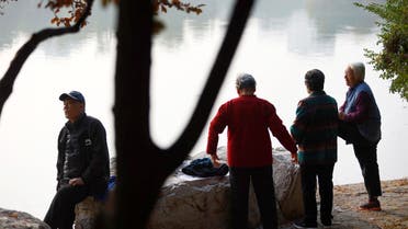 Elderly people rest by a lake at a park in Beijing, China November 10, 2022. (Reuters)