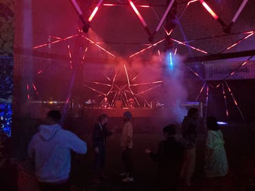 Photo shows attendees dancing within an audio-visual rig called the Polygon at the MDL Beast Soundstorm event in Riyadh. (Ayush Narayanan, Al Arabiya English)