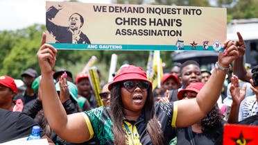 Members of the ruling African National Congress (ANC) and the South African Communist Party (SACP) sing and chant slogans as the picket outside the Kgosi Mampuru Correctional Facility in Pretoria, on 30 November 2022, against the release of Janusz Walus, who was charged with the 10 April 1993 killing of SACP Secretary-General Chris Hani. (AFP)