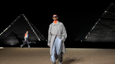 A model presents a creation at the Christian Dior fashion show at the Giza Pyramids Necropolis on the outskirts of the twin city of Egypt's capital on December 3, 2022. (AFP)