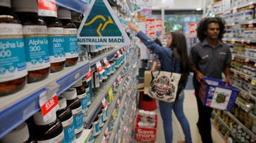 A shopper (L) browses for health products in an aisle stocked with vitamin supplements at a Mr Vitamins store in Sydney, Australia. (Reuters)