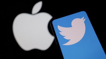 Smartphone with displayed Twitter logo is seen in front of Apple logo in this illustration. (Reuters)