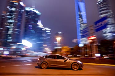 A Tesla electric vehicle (EV) drives past a crossing in Shanghai, China March 9, 2021. (File Photo: Reuters)