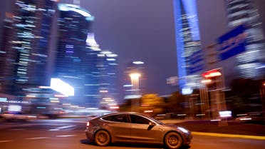 A Tesla electric vehicle (EV) drives past a crossing in Shanghai, China March 9, 2021. (File Photo: Reuters)