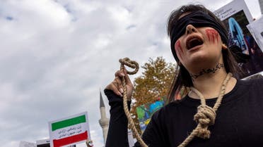 A member of the Iranian community living in Turkey holds a rope as letters on her neck reads, ”#no to death penalty” during a protest in support of Iranian women, after the death of Mahsa Amini, in Istanbul, Turkey November 19, 2022. (Reuters)