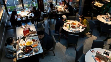 People dine at a restaurant in Beijing on June 6, 2022, following an easing of Covid restrictions in the Chinese capital. (AFP)