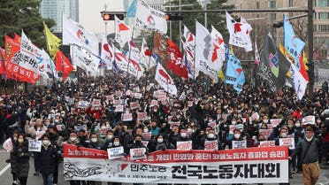 South Korean workers from the country's biggest labour union march during a rally in support of the ongoing strike by truckers near the National Assembly in Seoul, South Korea December 3, 2022. Yonhap/via REUTERS ATTENTION EDITORS - THIS IMAGE HAS BEEN SUPPLIED BY A THIRD PARTY. NO RESALES. NO ARCHIVES. SOUTH KOREA OUT. NO COMMERCIAL OR EDITORIAL SALES IN SOUTH KOREA.