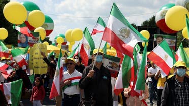 Supporters of the National Council of Resistance of Iran (NCRI) gather to protest against the government in Teheran and the use of the death penalty in Iran, in front of the Brandenburg Gate in Berlin, Germany, July 10, 2021. (Reuters)